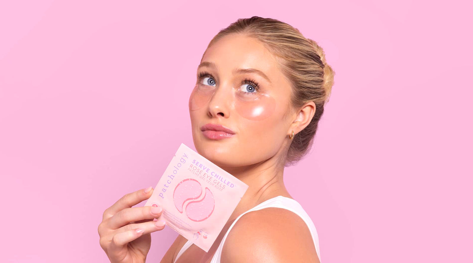 Rose serve chilled eye patches cooling summer skincare woman on a bright pink background