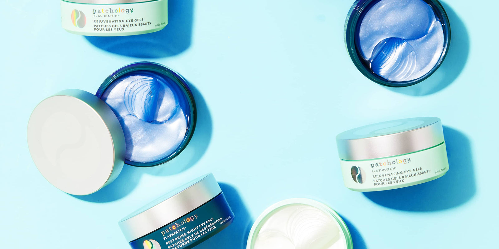 Patchology FlashPatch Rejuvenating and Restoring Night Eye Gel jars with shimmering blue and white hydrogel patches.