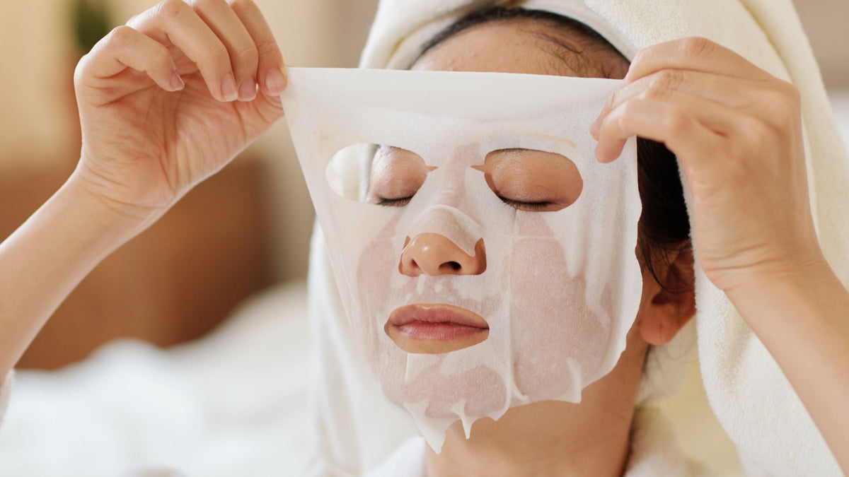 woman wearing an exfoliation sheet mask for brighter winter skin