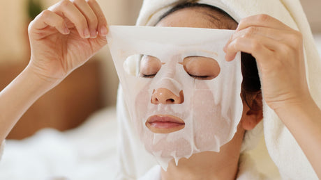 woman wearing an exfoliation sheet mask for brighter winter skin