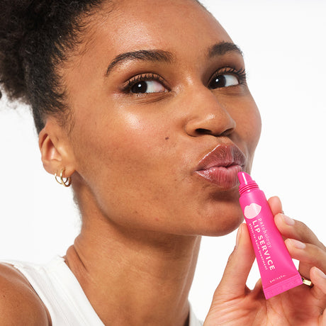lip service in use woman putting on gloss