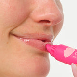 close up in use woman putting on lip service gloss